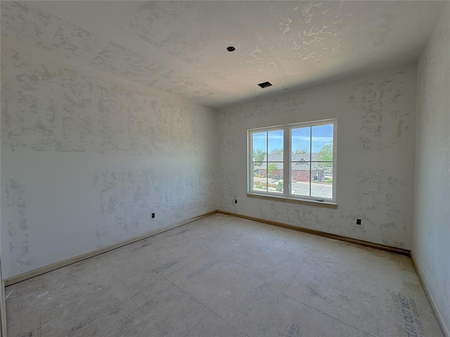 empty room featuring baseboards