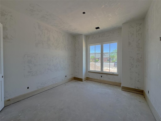 spare room with concrete flooring