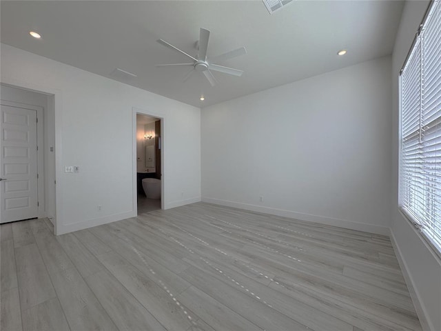 spare room with light wood-type flooring, a ceiling fan, baseboards, and recessed lighting