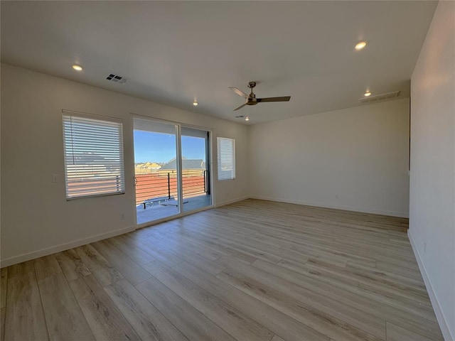 empty room with a ceiling fan, baseboards, visible vents, and light wood-style flooring