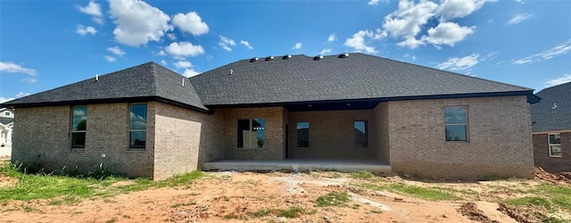 4129 Sambar St, Tuttle, OK 73089 - back of house featuring a patio area, brick siding, and a shingled roof