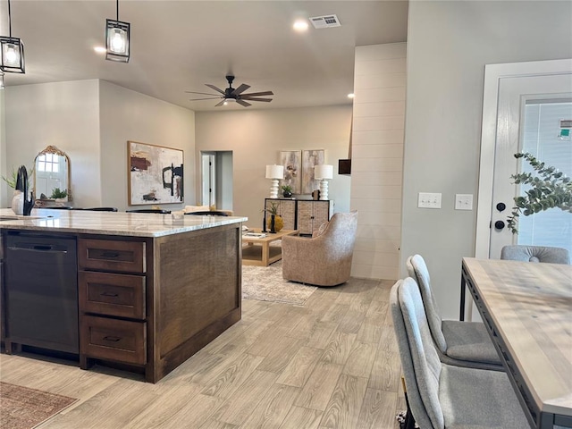 4129 Sambar St, Tuttle, OK 73089 - kitchen with dishwasher, light wood-style flooring, dark brown cabinets, ceiling fan, and open floor plan