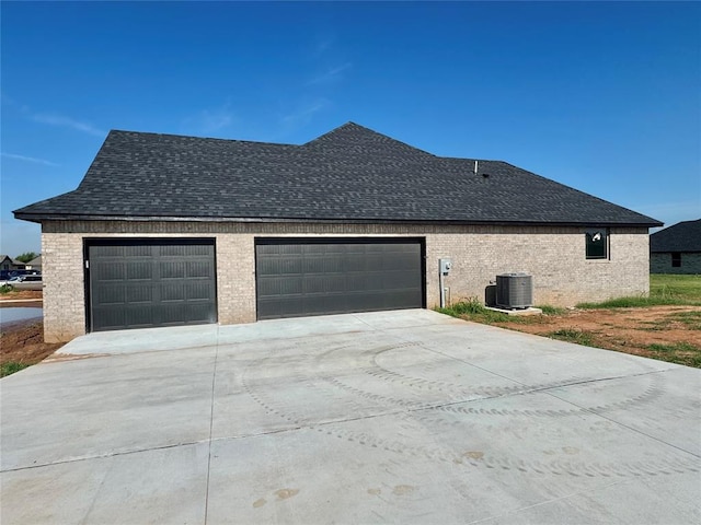 4129 Sambar St, Tuttle, OK 73089 - view of home's exterior with concrete driveway, roof with shingles, an attached garage, and brick siding