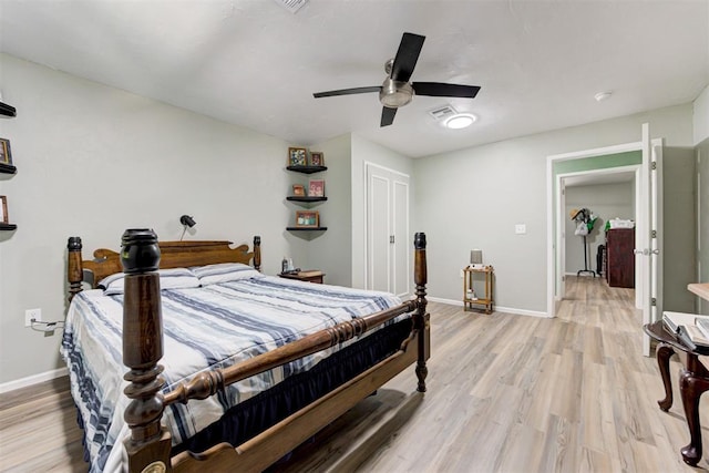bedroom featuring baseboards, a ceiling fan, and light wood-style flooring
