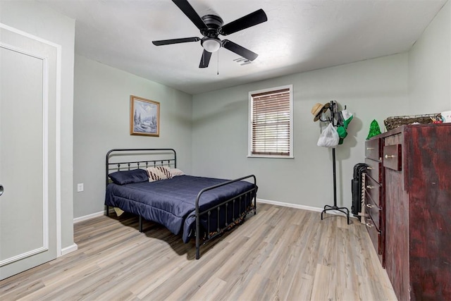 bedroom featuring ceiling fan, wood finished floors, and baseboards