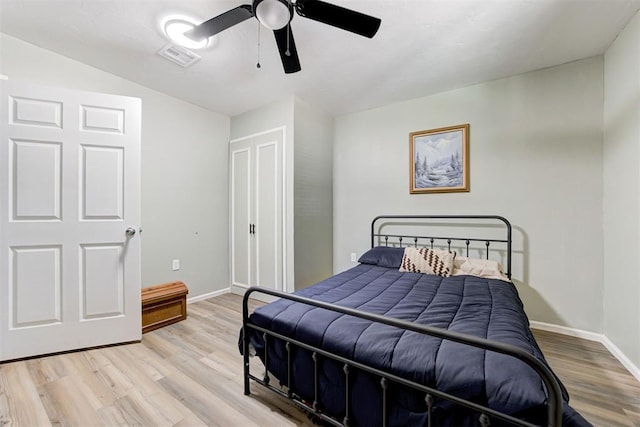 bedroom featuring visible vents, baseboards, ceiling fan, and light wood-type flooring
