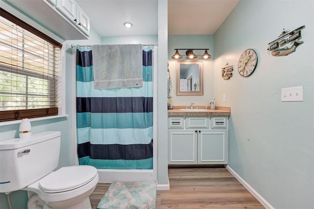 full bathroom with wood finished floors, toilet, a shower with shower curtain, and vanity
