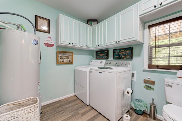 laundry room featuring light wood finished floors, laundry area, washer and clothes dryer, and electric water heater