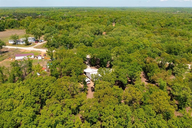 birds eye view of property featuring a wooded view