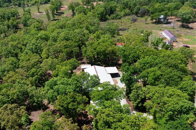 bird's eye view with a wooded view