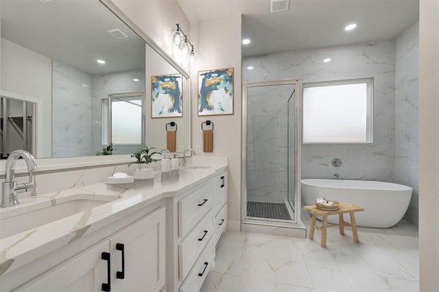 full bath with plenty of natural light, marble finish floor, and a marble finish shower