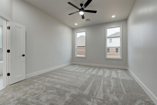 carpeted spare room with baseboards, ceiling fan, recessed lighting, and visible vents