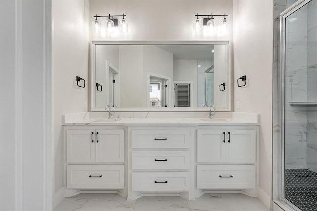 bathroom featuring double vanity, a marble finish shower, a sink, and marble finish floor