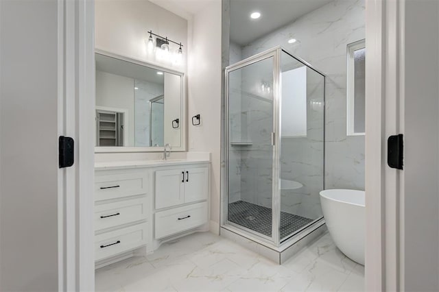 bathroom featuring a marble finish shower, a soaking tub, vanity, and marble finish floor