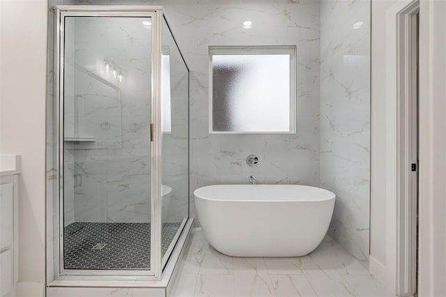 bathroom featuring a freestanding tub, a marble finish shower, vanity, and marble finish floor