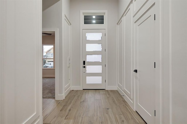 entryway featuring light wood-style floors and baseboards