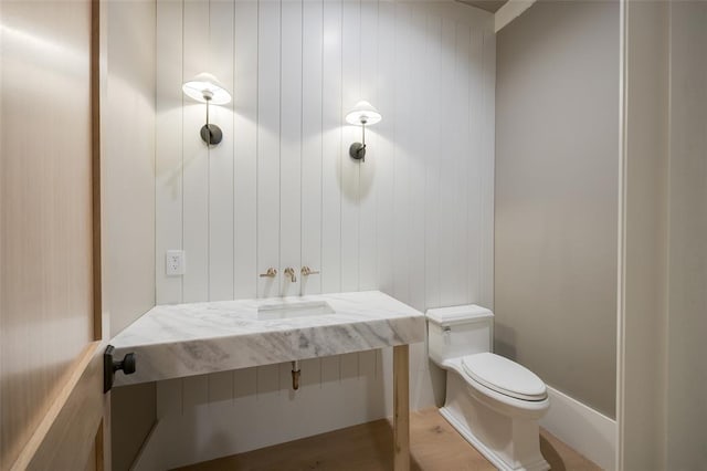half bathroom featuring toilet and vanity