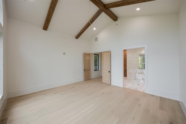 empty room featuring recessed lighting, light wood-style flooring, and beamed ceiling