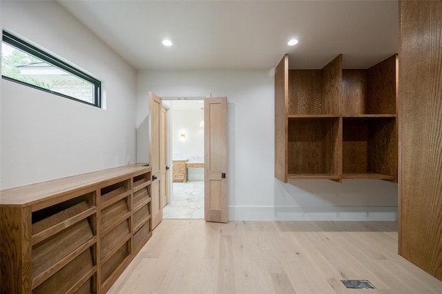 corridor featuring light wood-style floors and recessed lighting