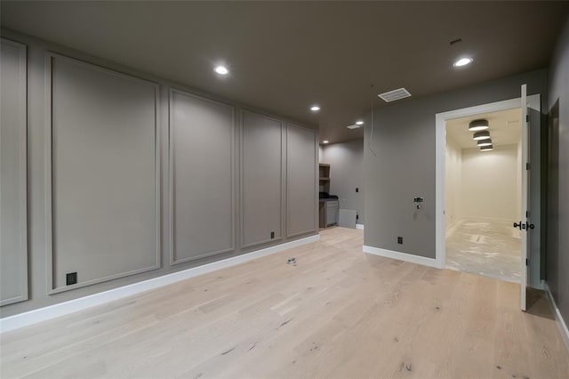 empty room with visible vents, light wood-type flooring, recessed lighting, and baseboards