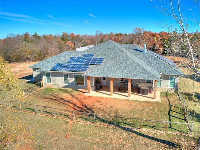 3537 W Fox Ln, Newcastle, OK 73065 - back of property featuring a lawn, solar panels, a fenced backyard, and a patio area