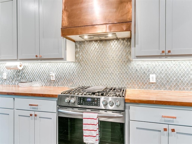3537 W Fox Ln, Newcastle, OK 73065 - kitchen with tasteful backsplash, stainless steel gas stove, custom exhaust hood, and wooden counters