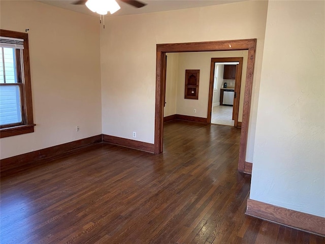 224 E Ayers St, Edmond, OK 73034 - empty room featuring a ceiling fan, baseboards, and dark wood-type flooring