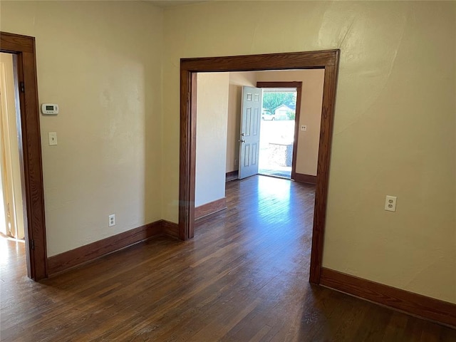 224 E Ayers St, Edmond, OK 73034 - hall featuring dark wood-type flooring and baseboards
