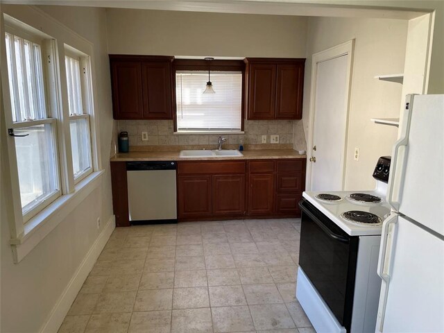 224 E Ayers St, Edmond, OK 73034 - kitchen with stainless steel dishwasher, a sink, light countertops, freestanding refrigerator, and electric stove