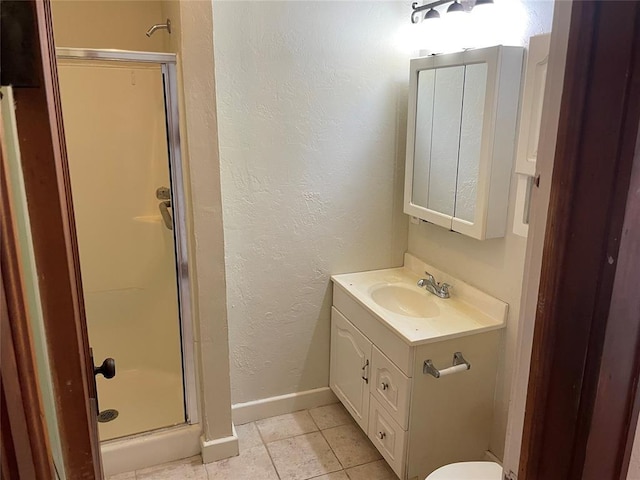 224 E Ayers St, Edmond, OK 73034 - full bath featuring a textured wall, a shower stall, vanity, and baseboards
