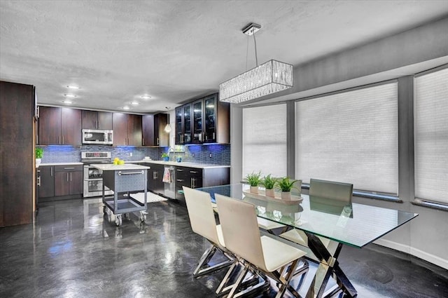 dining area with recessed lighting and finished concrete floors