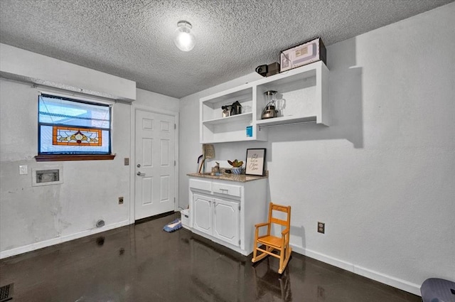 washroom featuring washer hookup, laundry area, a textured ceiling, baseboards, and hookup for an electric dryer