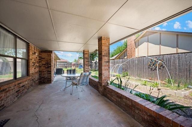 view of patio / terrace featuring outdoor dining area, a fenced backyard, and cooling unit