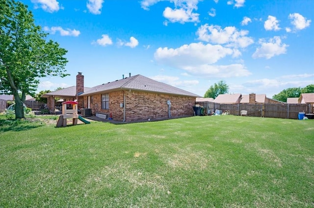 view of yard featuring fence and central AC unit