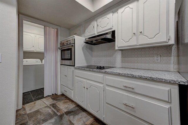 kitchen featuring washer / dryer, under cabinet range hood, white cabinets, and oven
