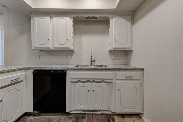 kitchen with a sink, white cabinetry, backsplash, and black dishwasher