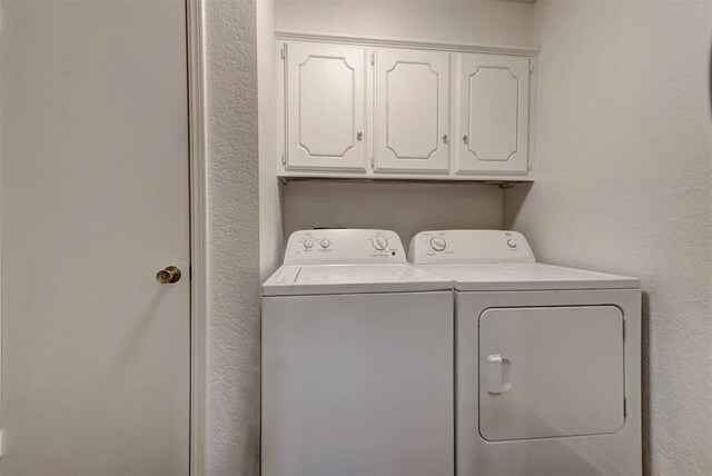 laundry area featuring cabinet space and independent washer and dryer