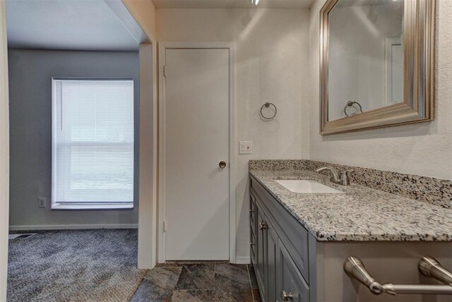 bathroom with vanity and baseboards