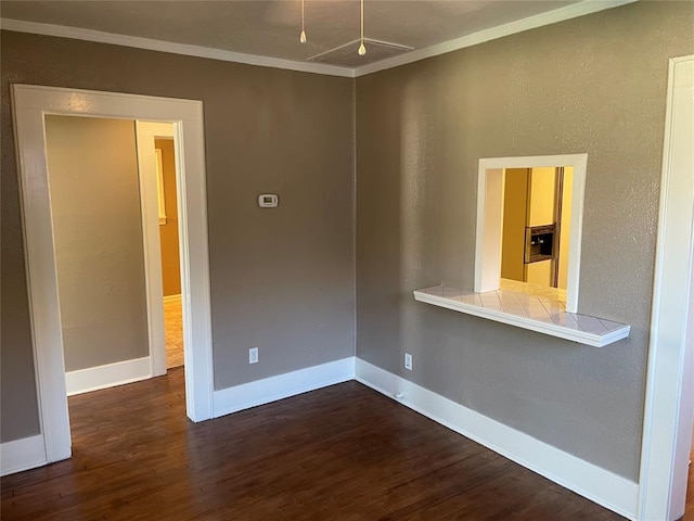 230 E Ayers St, Edmond, OK 73034 - spare room with dark wood finished floors, baseboards, and crown molding