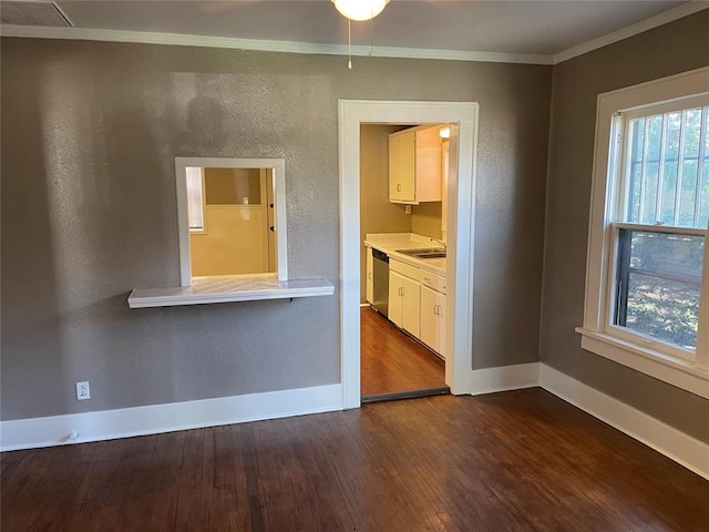 230 E Ayers St, Edmond, OK 73034 - unfurnished room with dark wood-style floors, baseboards, ornamental molding, and a sink