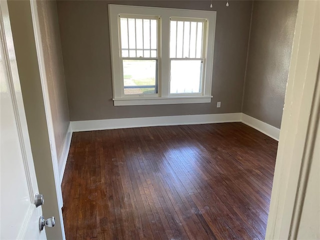 230 E Ayers St, Edmond, OK 73034 - empty room featuring dark wood-style flooring and baseboards