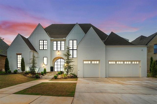 view of front of house featuring board and batten siding, concrete driveway, and a garage