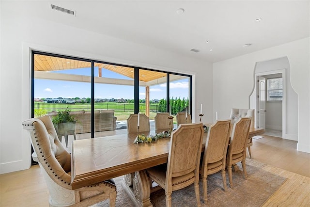 dining space featuring baseboards, visible vents, and a wealth of natural light
