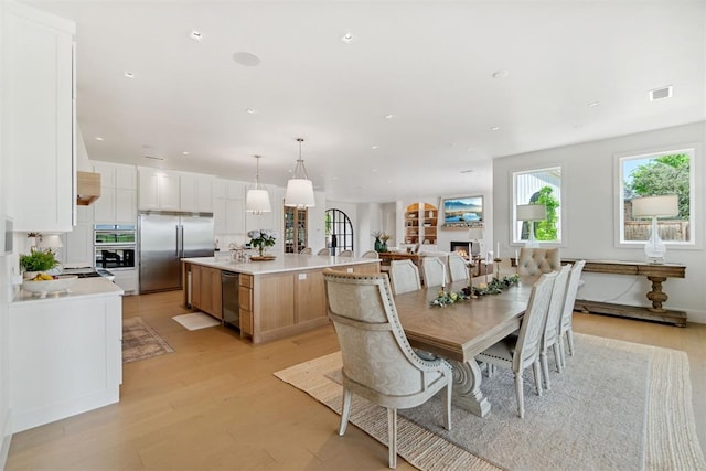 dining area with visible vents, light wood-style floors, and recessed lighting
