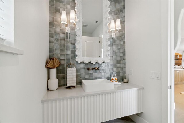 bathroom with vanity and decorative backsplash