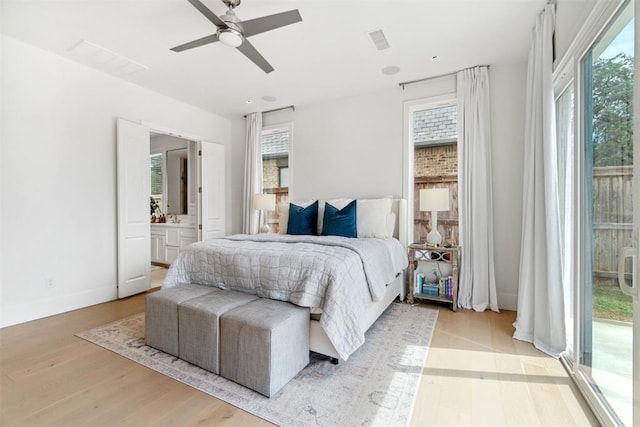bedroom with visible vents, light wood-style floors, and multiple windows
