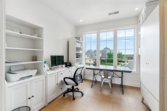 office space with baseboards, visible vents, light wood-style floors, and recessed lighting