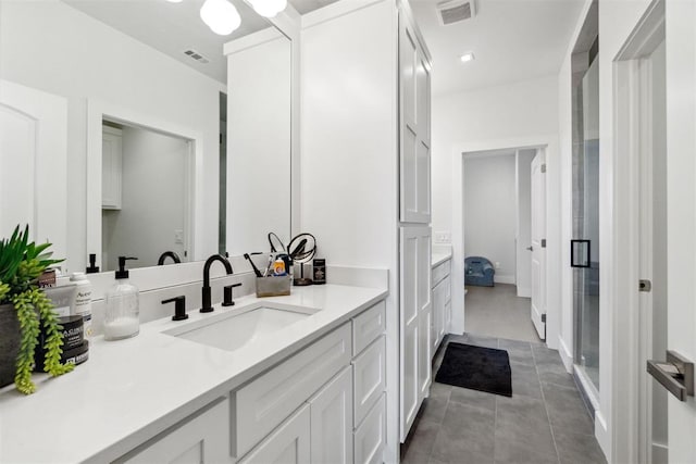 full bathroom with visible vents, vanity, and tile patterned flooring