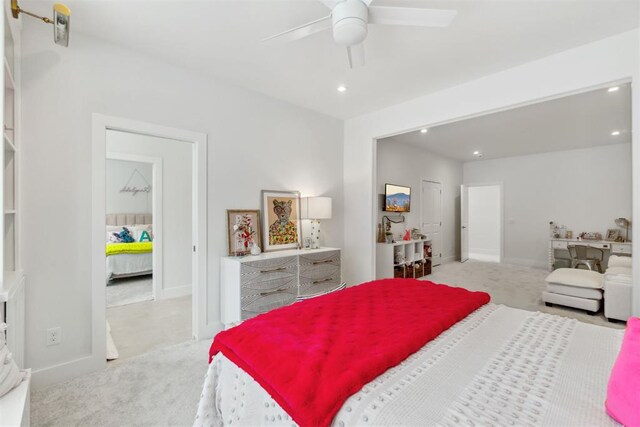 bedroom with light colored carpet, recessed lighting, and baseboards