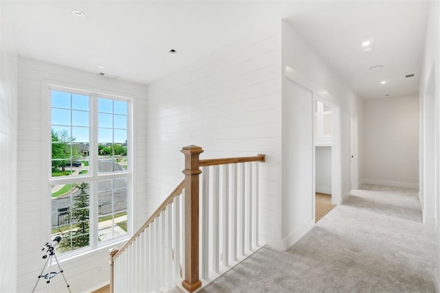 corridor featuring baseboards, recessed lighting, an upstairs landing, and carpet